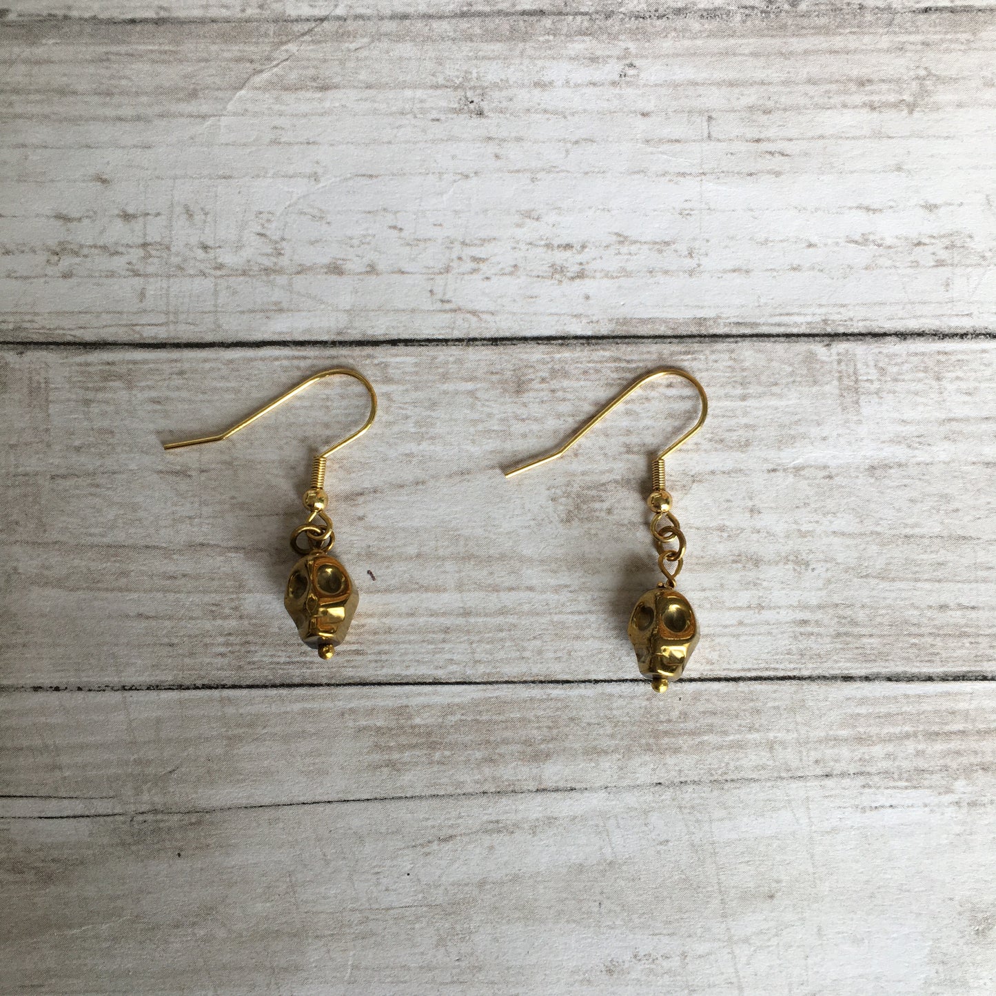The Golden Hematite Skull Earrings